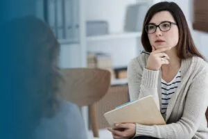 female counselor listens to client in environment where honesty is encouraged bl