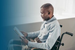 senior african american american man in wheelchair reading bl