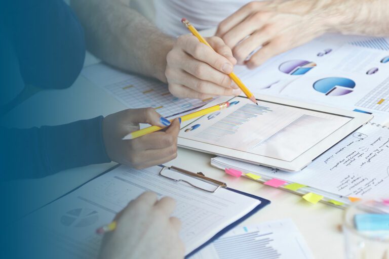 three people at table examining financial documents financial assistance