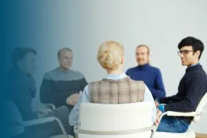 five adults talking in group session