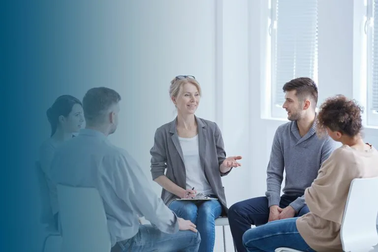 psychotherapist and four clients sitting in spacious bright office