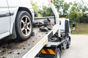 car being loaded onto bed of tow truck