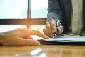 cropped man and woman reviewing important document before signing