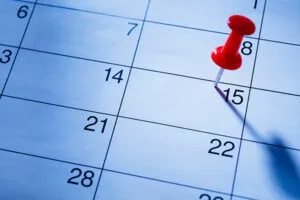 red pin marking the 15th on a calendar